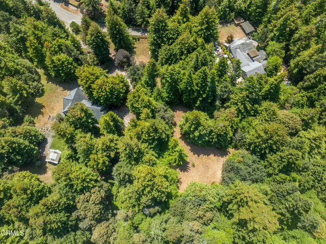 a backyard of a house with a yard and outdoor seating