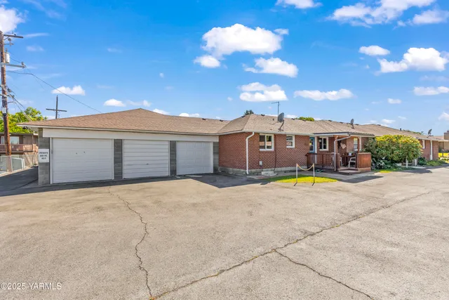 a view of a house with a swimming pool and a yard