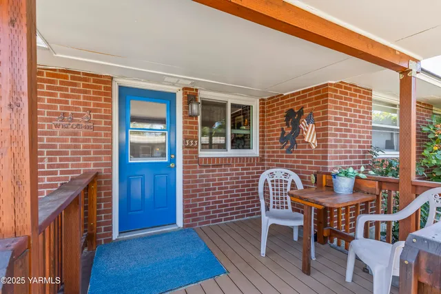 a balcony with table and chairs