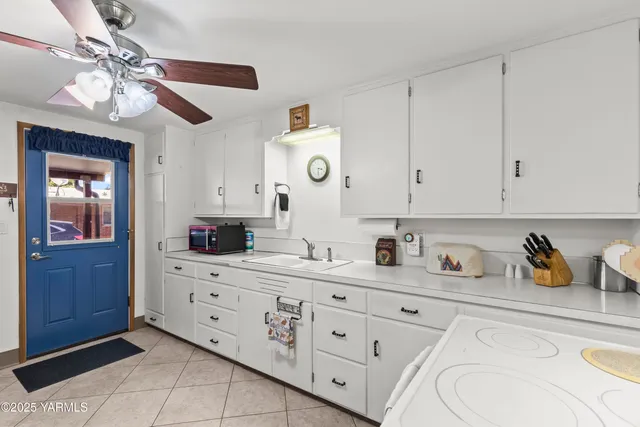 a kitchen with cabinets stainless steel appliances a sink and a window