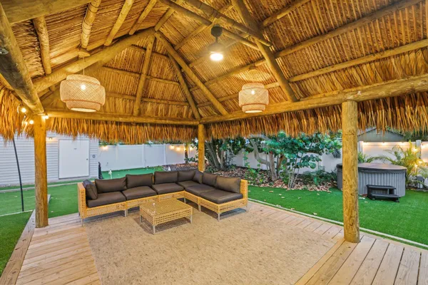 a backyard of a house with a garden and barbeque oven