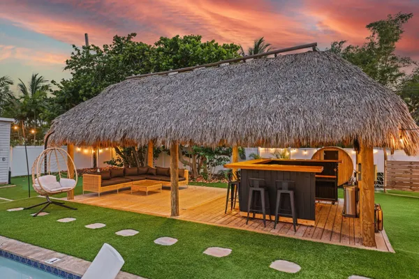 a view of a swimming pool with a patio and a yard