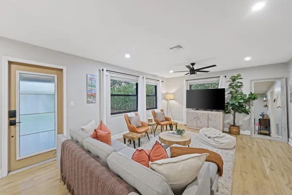 a living room with furniture and a flat screen tv