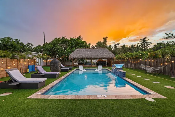 a view of a house with swimming pool yard and outdoor seating