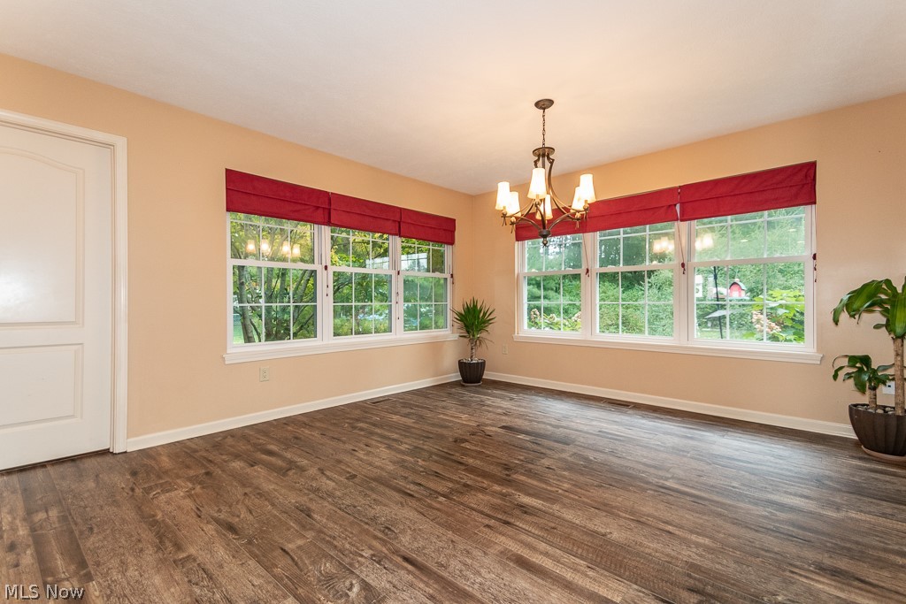1074 Dock Road Madison, OH 44057 - Photo 9 of 35 Oversized morning room with three walls of windows. Door leads to walk-in pantry/mechanical room.
