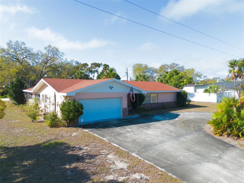 201 Harbor Bluff Drive Largo, FL 33770 - Photo 1 of 1 a front view of a house with a yard and garage