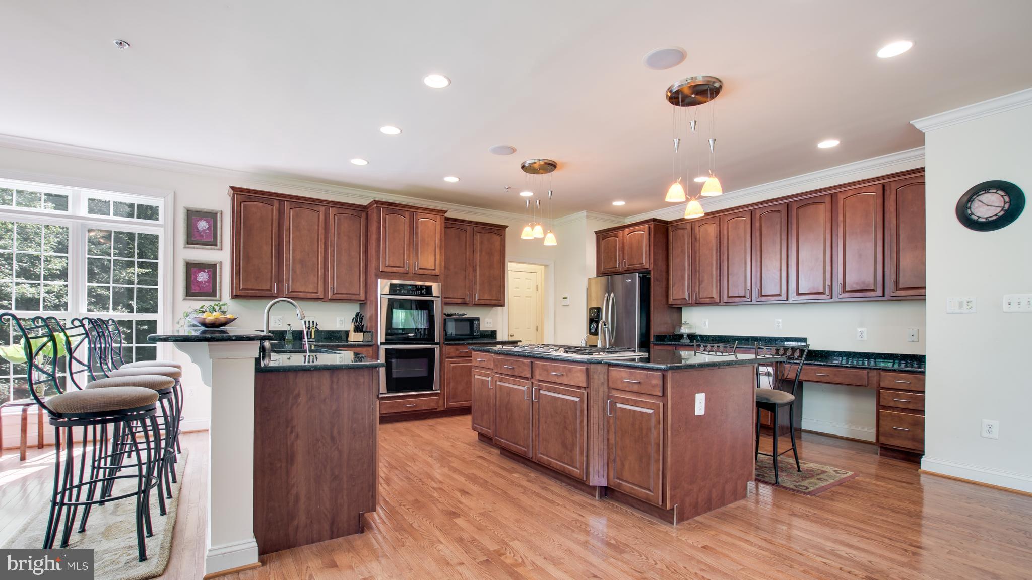 8901 Normal School Road Bowie, MD 20715 - Photo 13 of 82 A LG GRANITE COUNTER HAS COOK TOP, SINK AND SEATS,