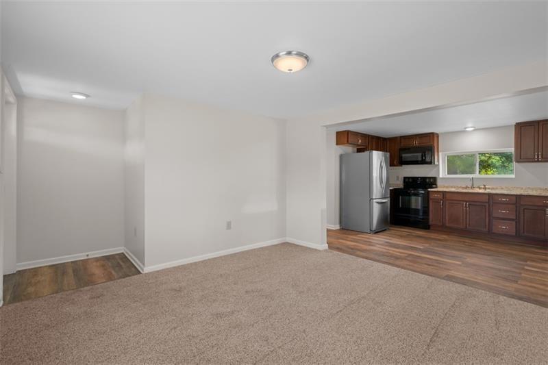 1122 Pittsburgh Road Valencia, PA 16059 - Photo 10 of 18 a view of an empty room with kitchen and a window