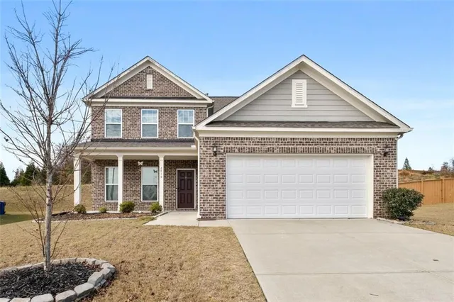 a front view of a house with a yard