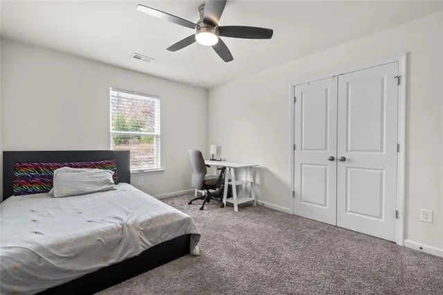 a bedroom with a bed and a table in it