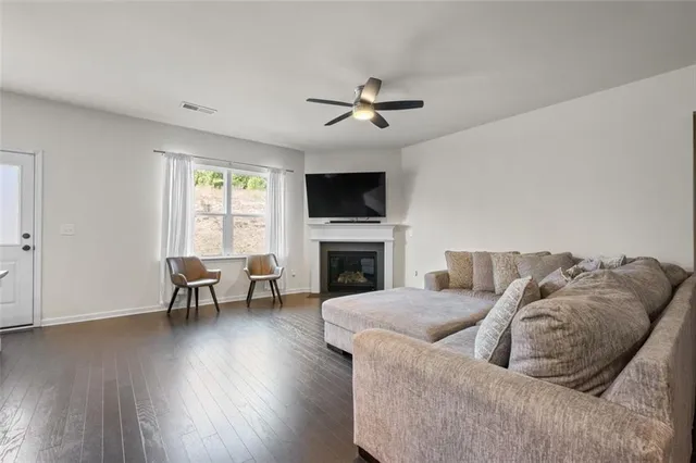 a living room with furniture a fireplace and a flat screen tv