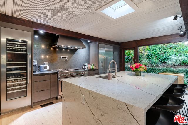 a kitchen with sink refrigerator and stove