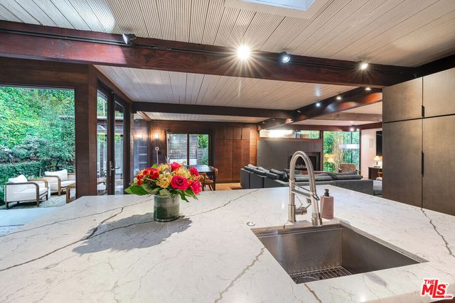 a kitchen with furniture and a large window