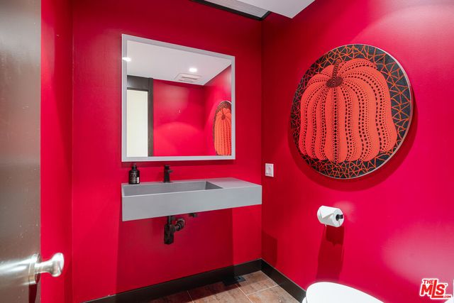 a bathroom with a mirror and a sink