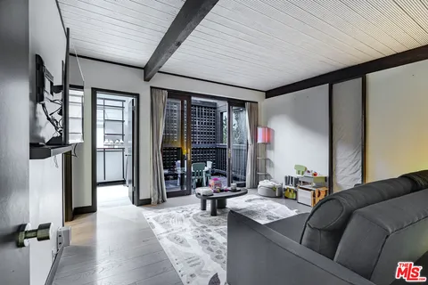 a living room with furniture fireplace and flat screen tv