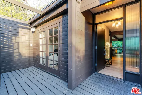 a view of a porch with wooden floor and furniture