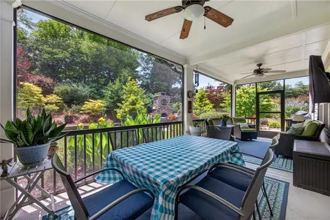 a view of a patio with a table chairs and a potted plant