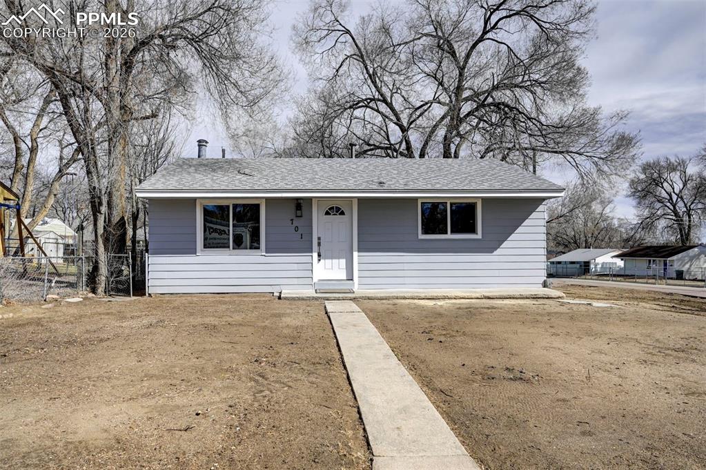 a front view of a house with a trees