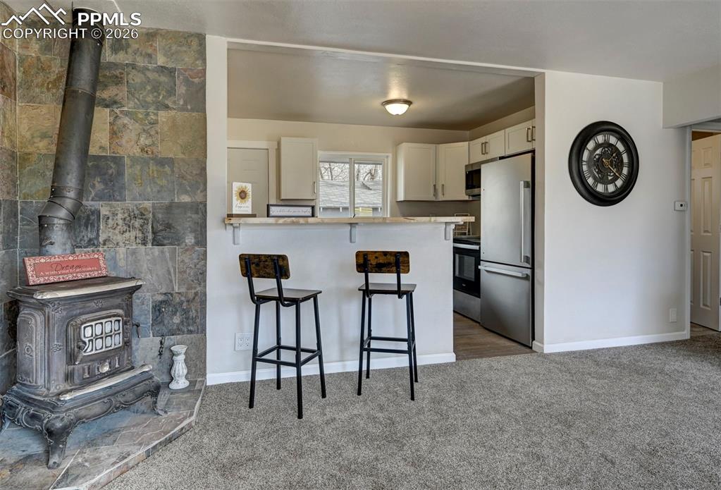 701 Erie Road Colorado Springs, CO 80910 - Photo 11 of 27 a kitchen with stainless steel appliances granite countertop a stove and a refrigerator with white cabinets