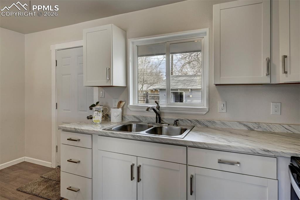 701 Erie Road Colorado Springs, CO 80910 - Photo 13 of 27 a kitchen with a sink and cabinets