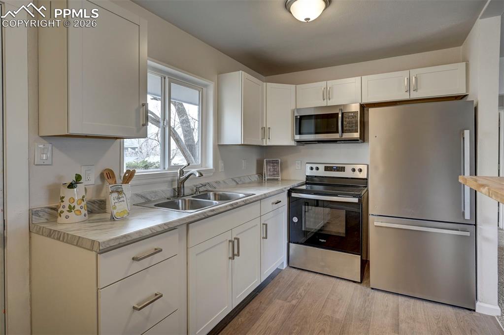 701 Erie Road Colorado Springs, CO 80910 - Photo 14 of 27 a kitchen with a refrigerator stove and sink