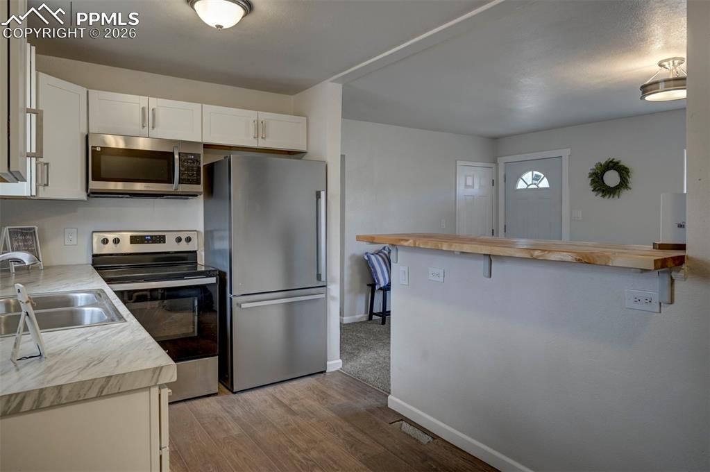 701 Erie Road Colorado Springs, CO 80910 - Photo 15 of 27 a kitchen with a refrigerator stove and microwave