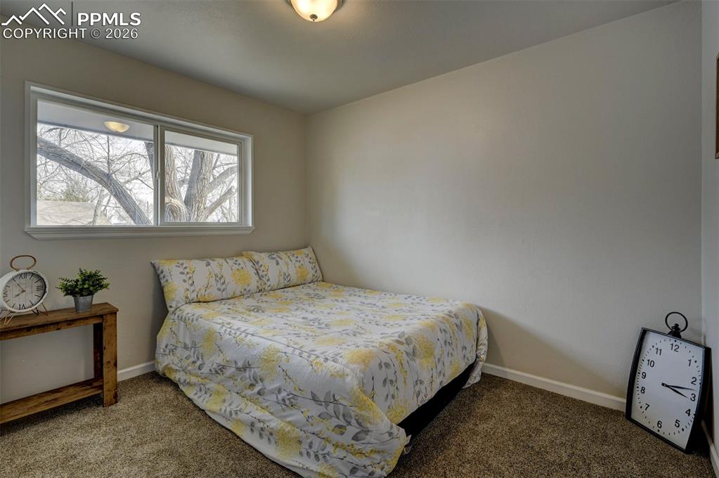 701 Erie Road Colorado Springs, CO 80910 - Photo 20 of 27 a bedroom with a bed and windows