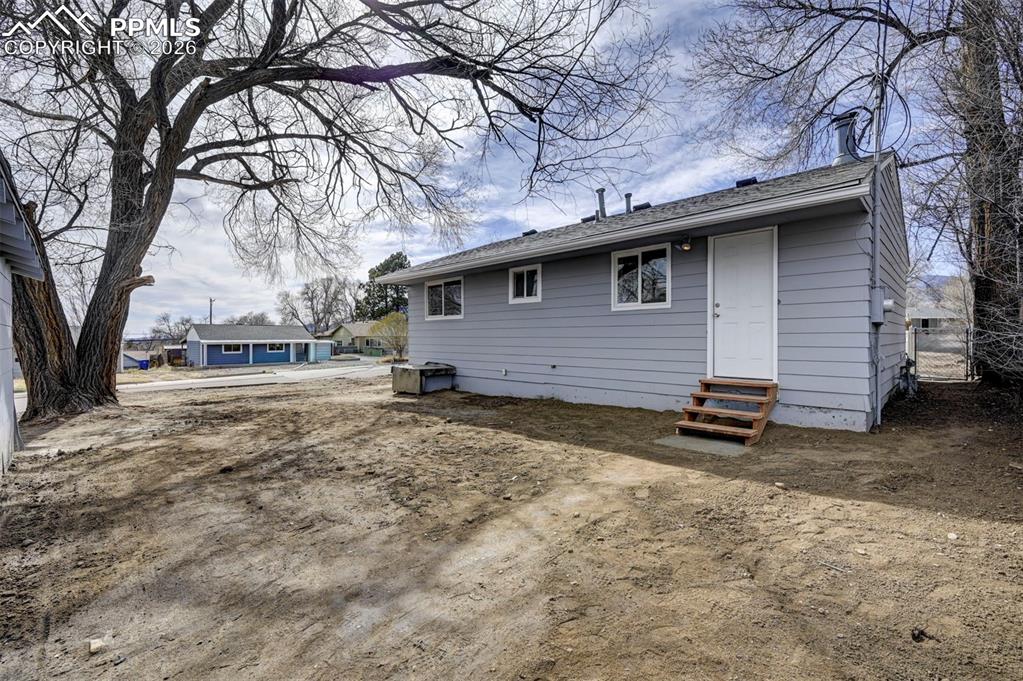 701 Erie Road Colorado Springs, CO 80910 - Photo 24 of 27 a backyard of a house with large trees and a tree