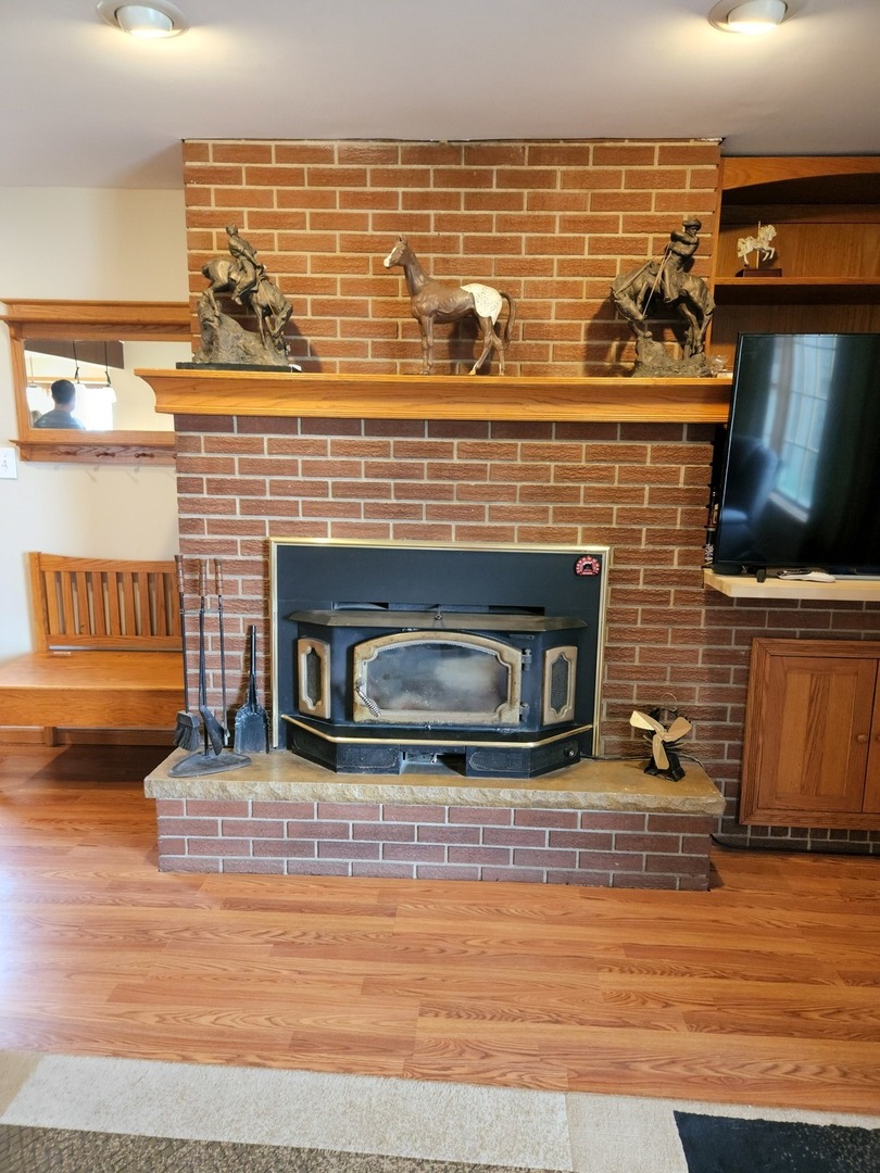 32443 Wilton Road Manteno, IL 60950 - Photo 14 of 48 a view of a fireplace with wooden floor