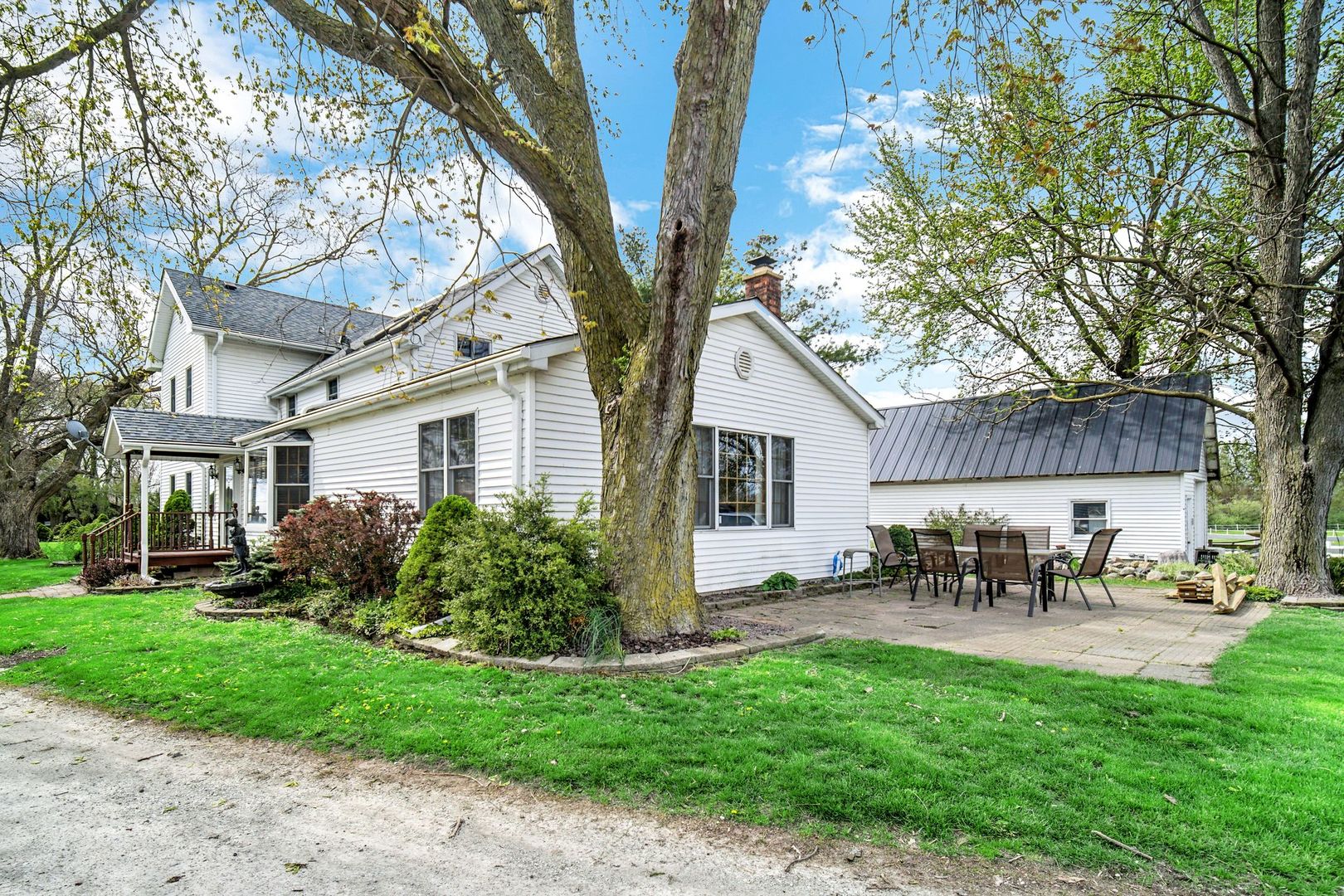 32443 Wilton Road Manteno, IL 60950 - Photo 5 of 48 a front view of a house with garden and sitting area