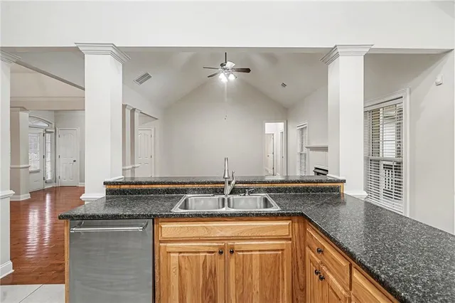 a kitchen with granite countertop a sink and cabinets