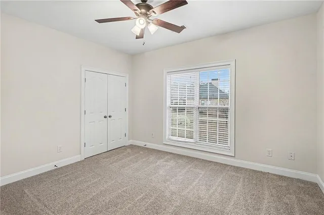 an empty room with chandelier fan