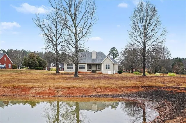 a front view of a house with a yard and trees