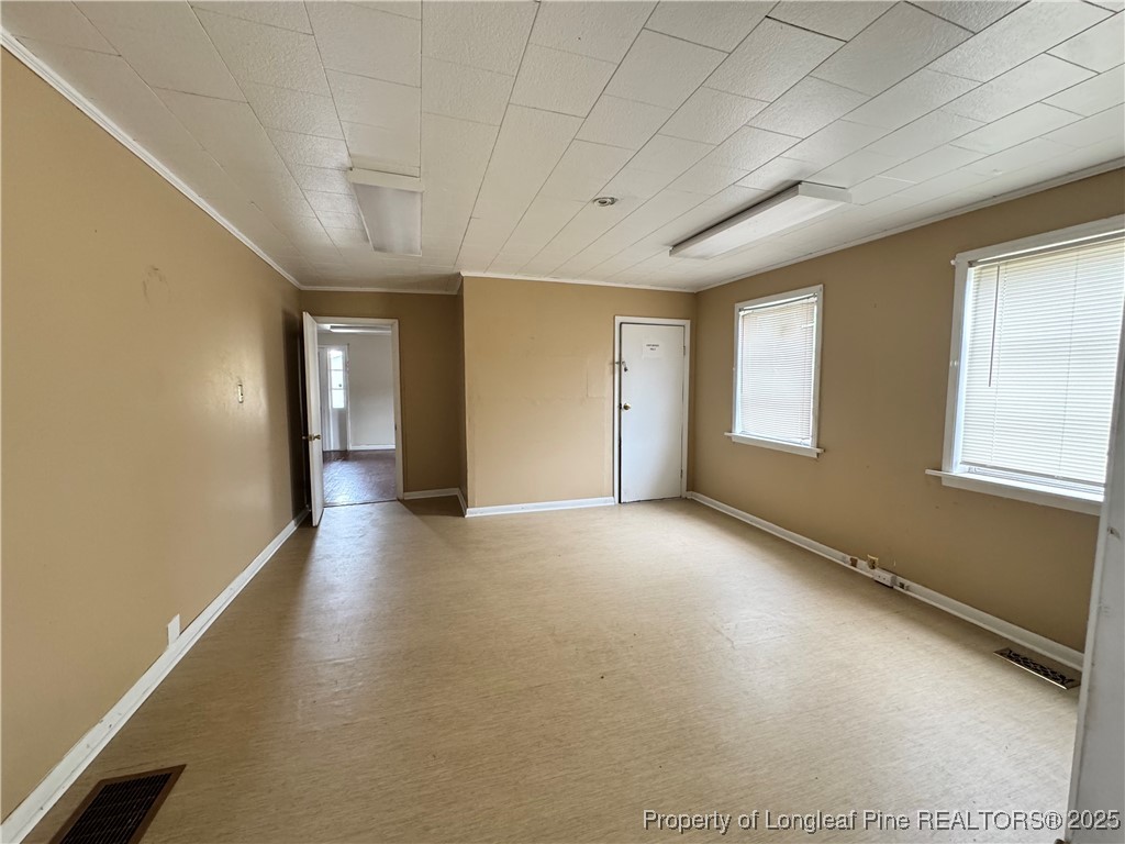 202 Main Street Hamlet, NC 28345 - Photo 5 of 10 an empty room with windows and closet