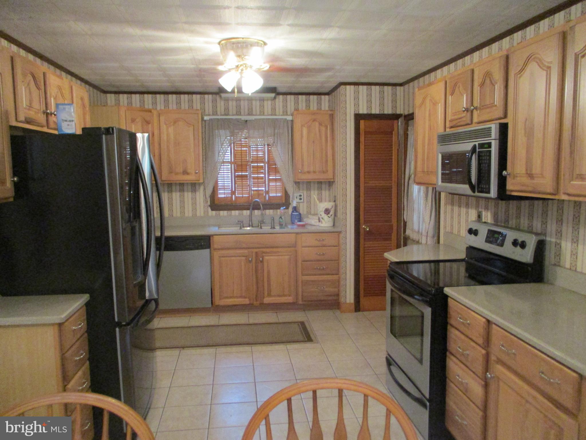 807 Green Glade Road Swanton, MD 21561 - Photo 7 of 12 a kitchen with a refrigerator sink and stove