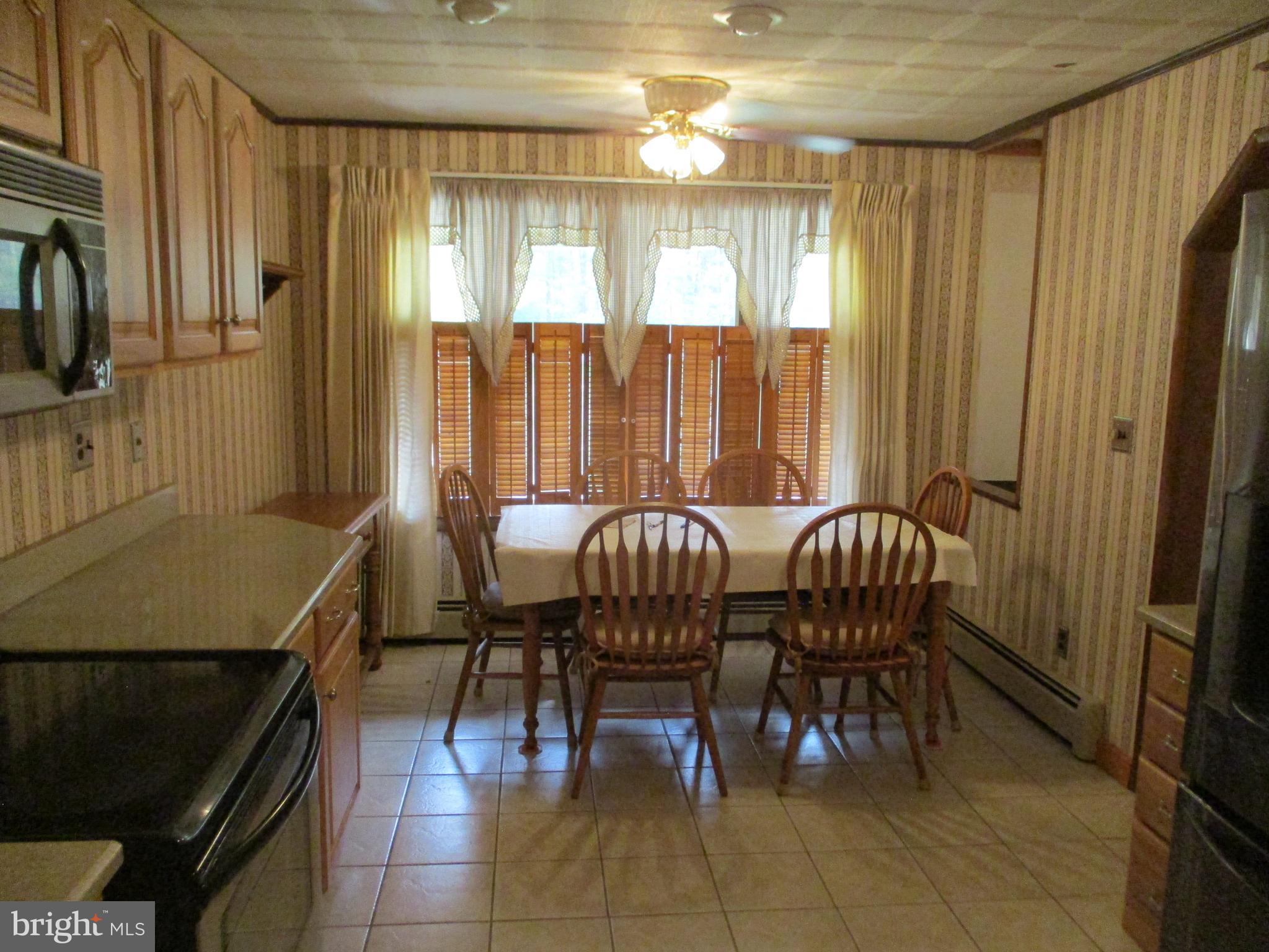 807 Green Glade Road Swanton, MD 21561 - Photo 8 of 12 a view of a a dining room with furniture window and outside view