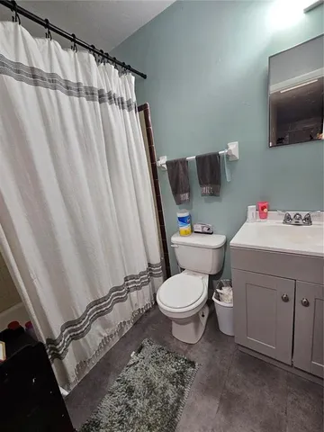 a view of a backyard with wooden fence