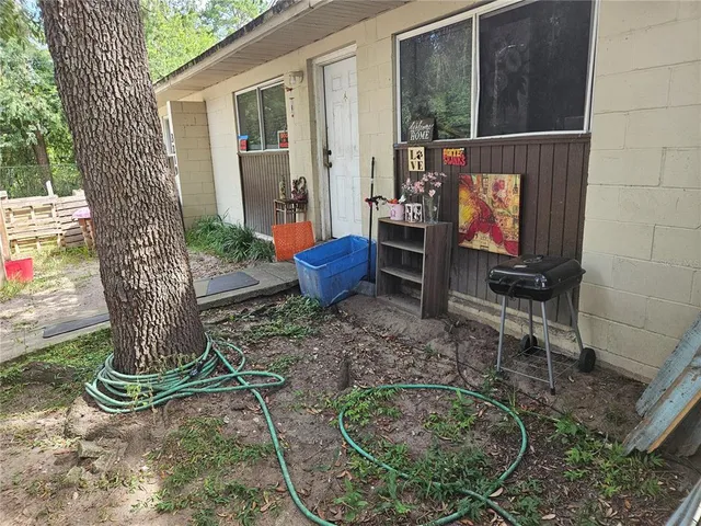 a view of house and car parked in back yard