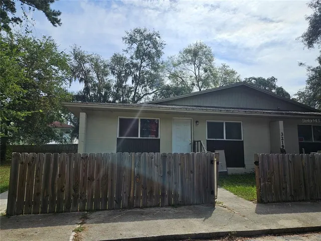 a front view of a house with wooden fence