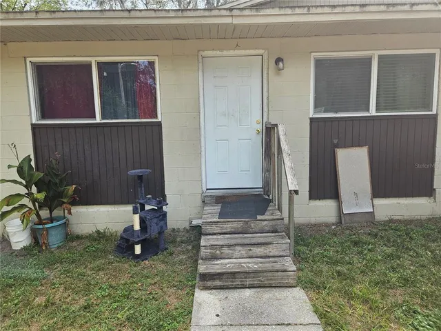 a view of a backyard with sitting area