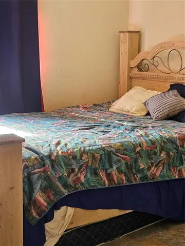 a bedroom with a bed and a table