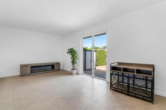 an entryway with a table and chairs