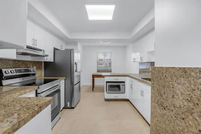 a kitchen with cabinets and stainless steel appliances