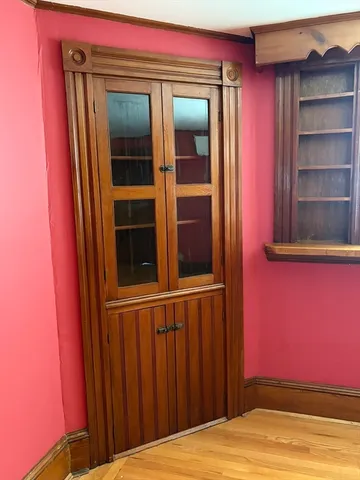 a view of a house with a door and wooden floor