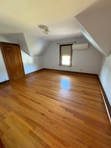 a view of a livingroom with wooden floor and a ceiling fan
