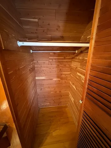 a view of a room with wooden floor and staircase