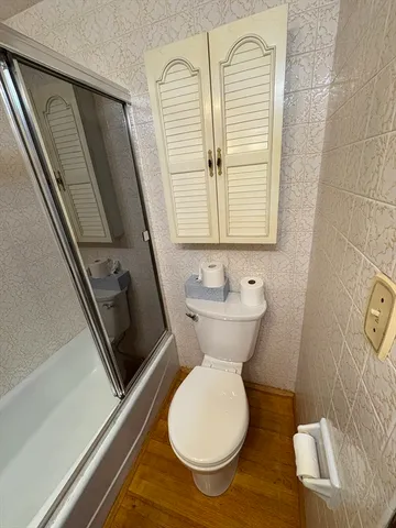 a view of a hardwood and an entryway