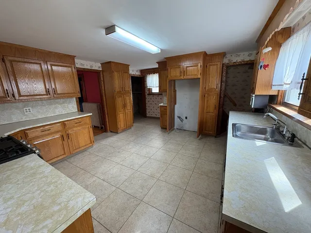 a kitchen with stainless steel appliances granite countertop a refrigerator and a stove