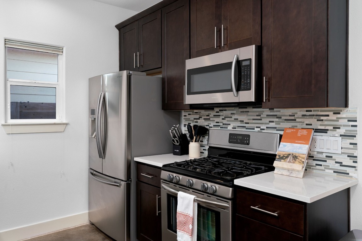 3012 Neal Street Austin, TX 78702 - Photo 11 of 39 a kitchen with stainless steel appliances a stove a microwave a sink and cabinets