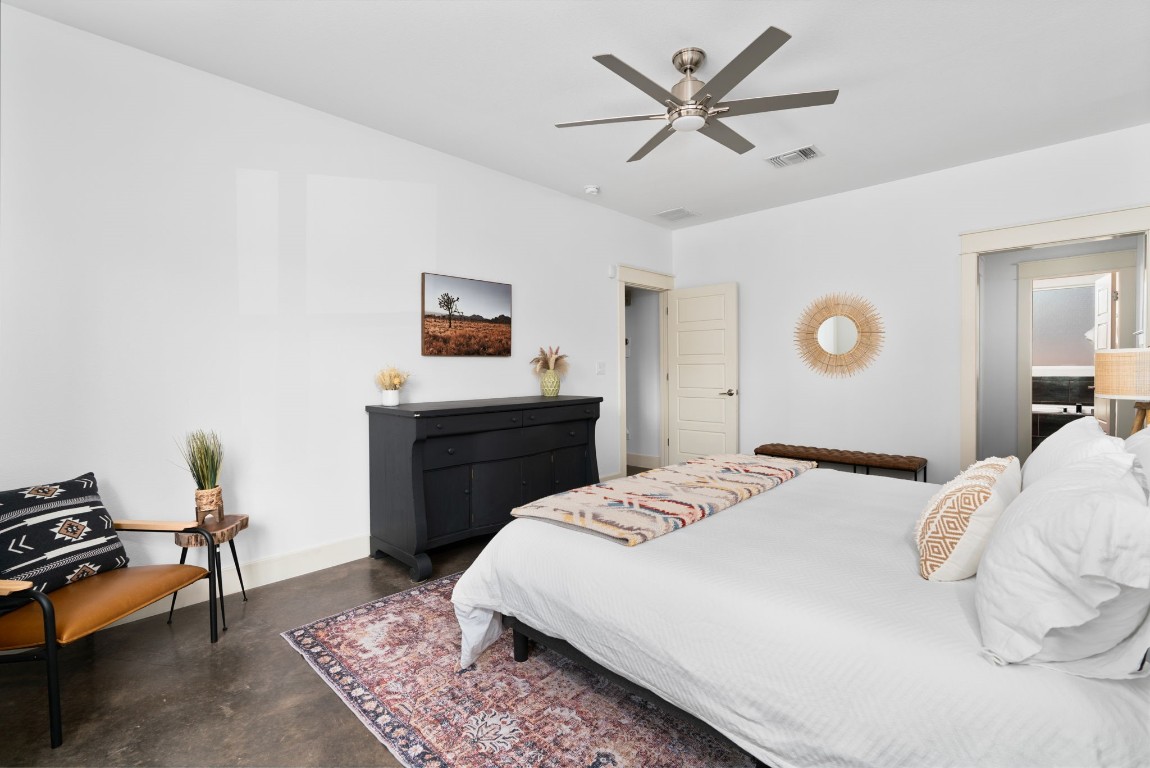 3012 Neal Street Austin, TX 78702 - Photo 19 of 39 a bedroom with a bed and a chandelier